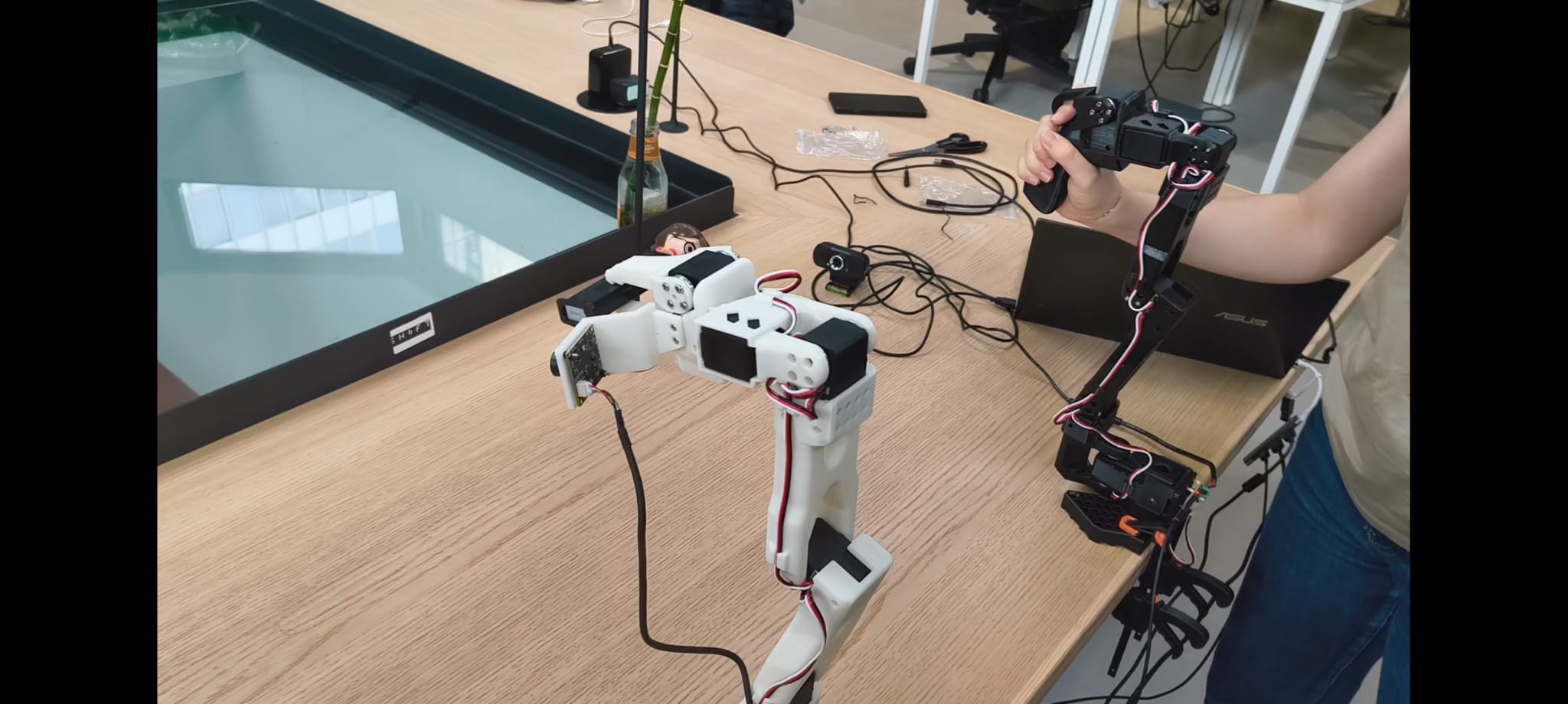 Two robotic arms being tested on a worktable for the Embodia project