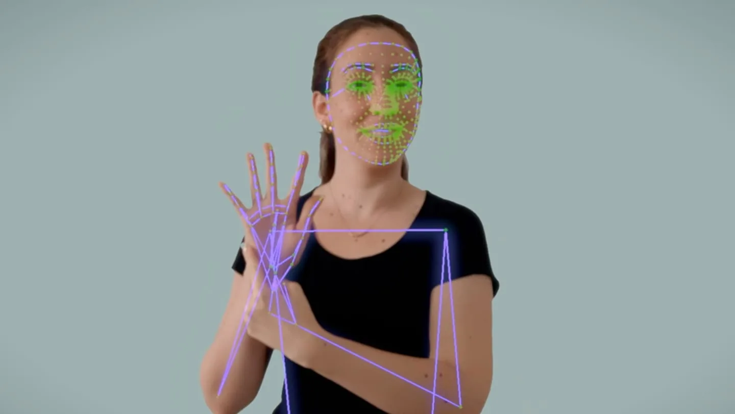 Person raising a hand with face, hand, and body tracking landmarks overlaid